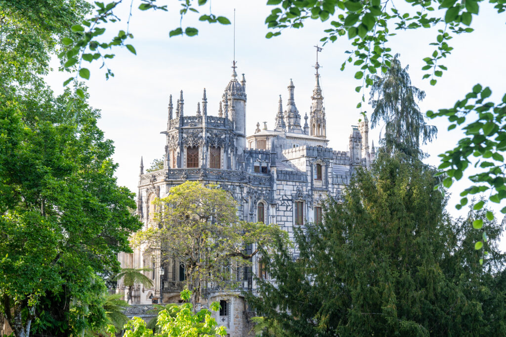 A scenic view of Quinta da Regaleira, showcasing its intricate architecture and lush gardens in Sintra, Portugal